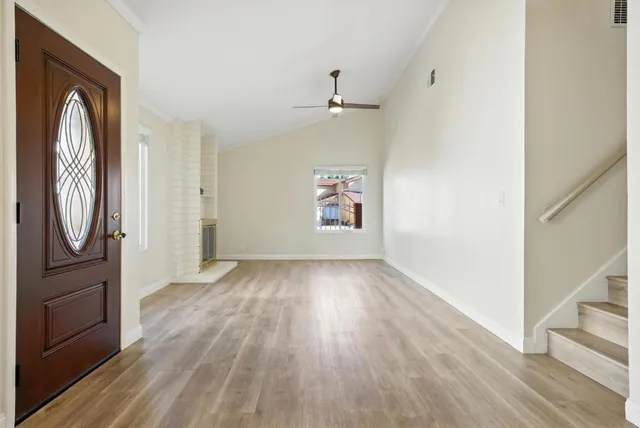 wooden floor in an empty room with a window