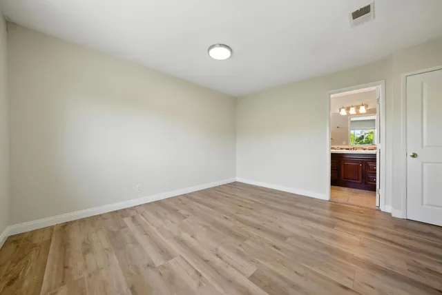 a view of an empty room and wooden floor