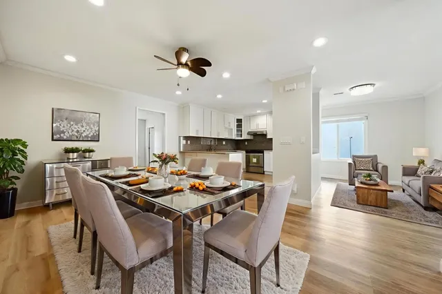 a dining room with furniture and wooden floor