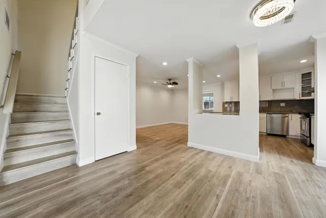 a view of a kitchen with wooden floor and a kitchen