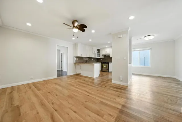 a view of a kitchen with a sink stainless steel appliances and cabinets