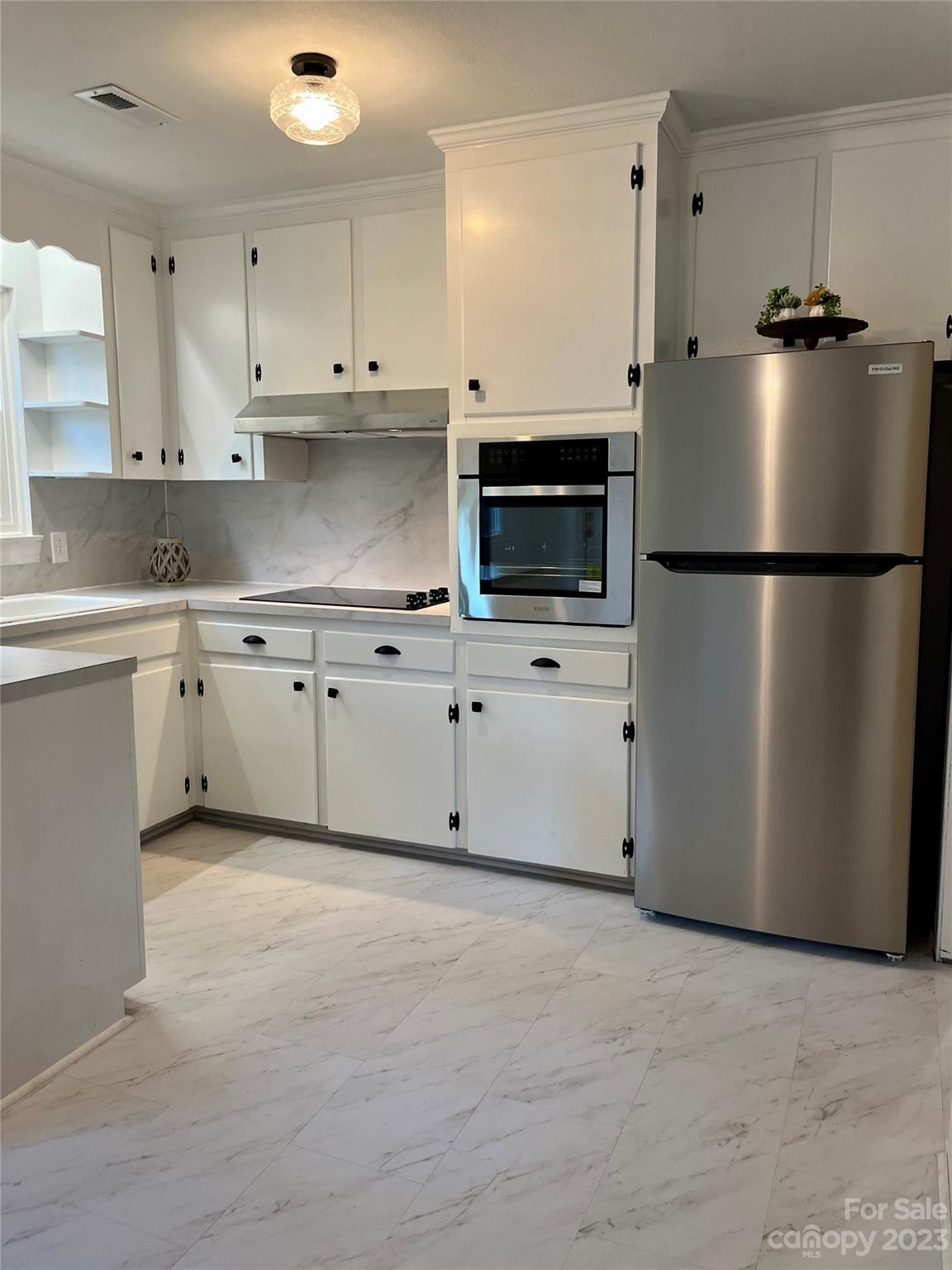 35 Circle Loop Stony Point, NC 28678 - Photo 21 of 46 a kitchen with stainless steel appliances granite countertop a refrigerator a stove a sink and white cabinets