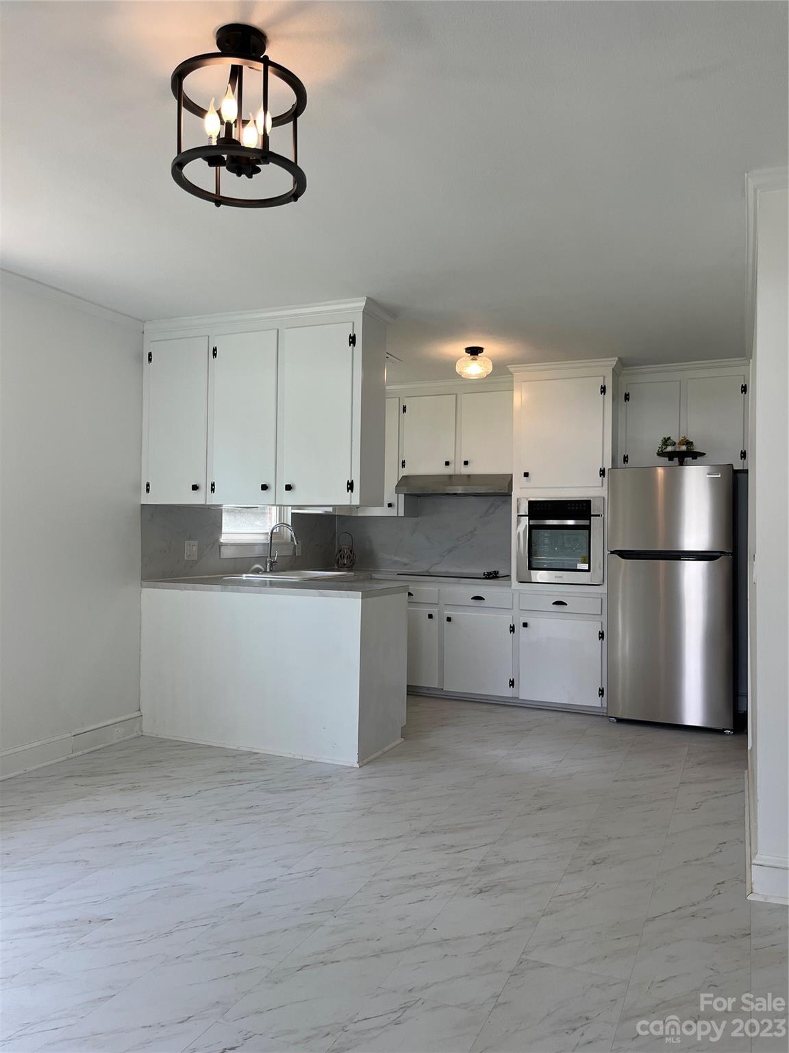 35 Circle Loop Stony Point, NC 28678 - Photo 3 of 46 a kitchen with stainless steel appliances a refrigerator a stove a microwave and cabinets