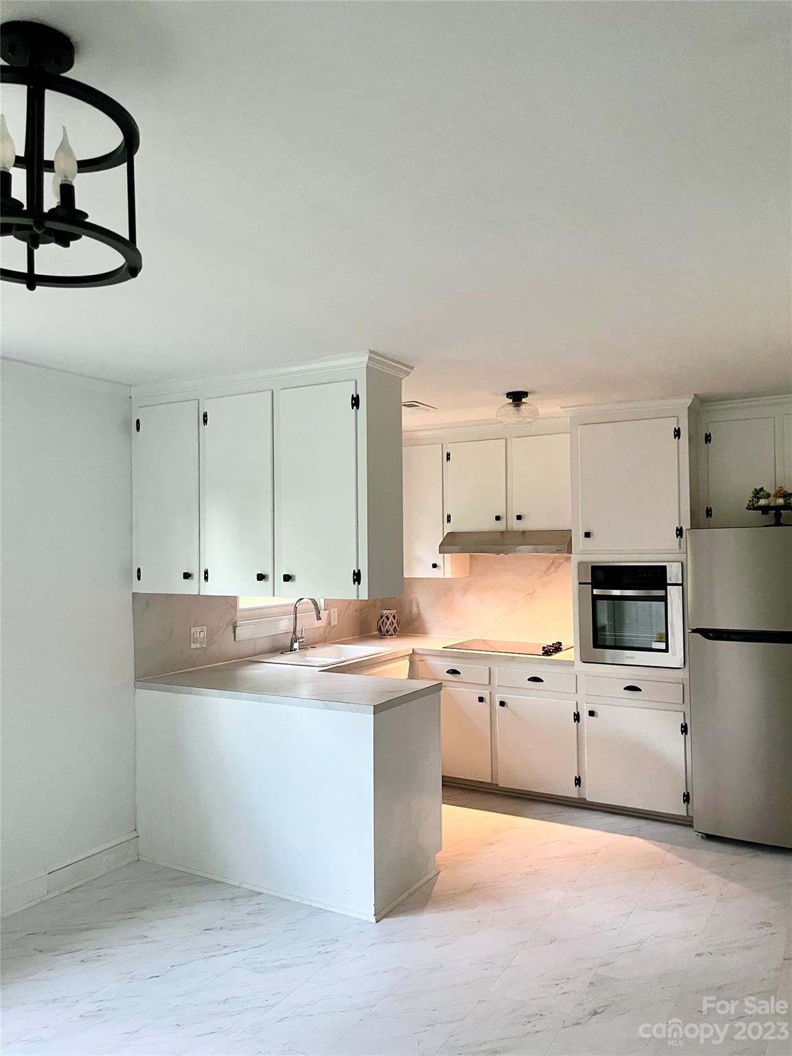 35 Circle Loop Stony Point, NC 28678 - Photo 7 of 46 a kitchen with white cabinets and white appliances