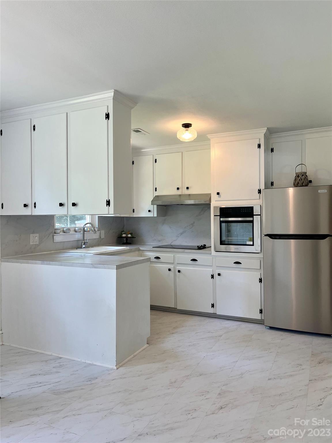 35 Circle Loop Stony Point, NC 28678 - Photo 8 of 46 a kitchen with stainless steel appliances a refrigerator sink and white cabinets