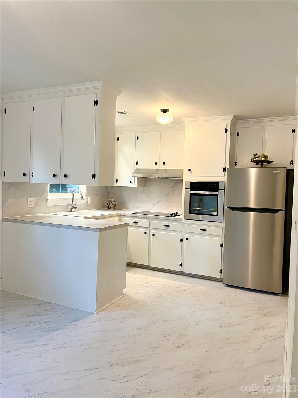 35 Circle Loop Stony Point, NC 28678 - Photo 10 of 46 a kitchen with stainless steel appliances white cabinets and a refrigerator