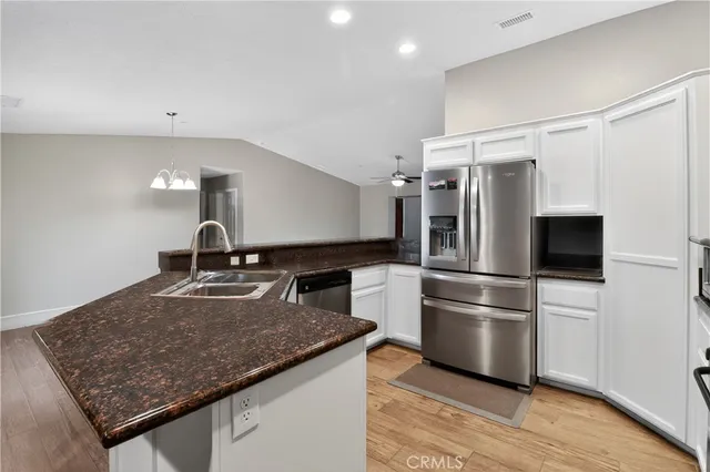 a kitchen with a refrigerator and a sink