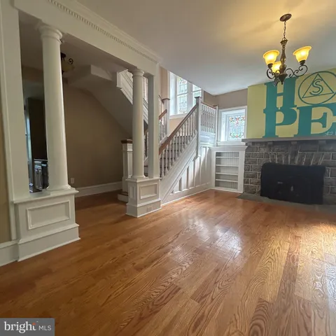 wooden floor in an empty room with a fireplace