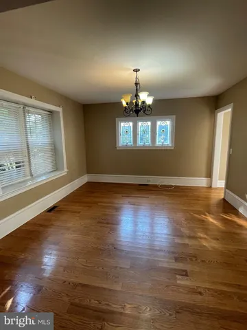 a view of an empty room and wooden floor