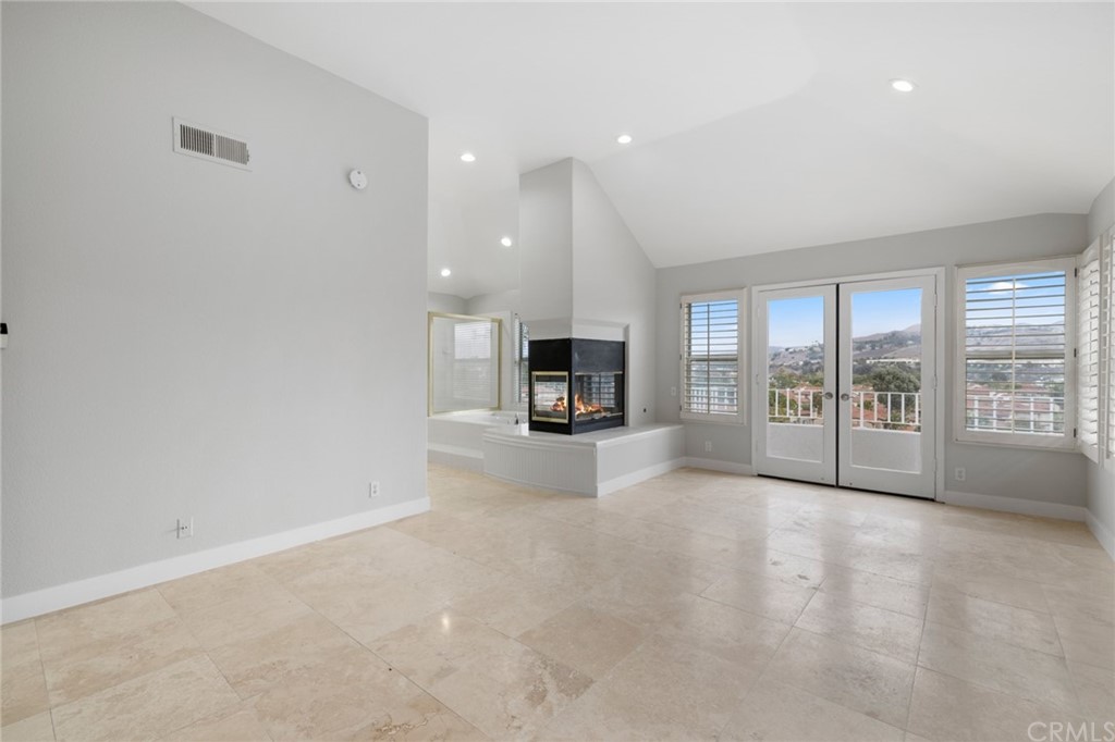33696 Bridgehampton Drive Dana Point, CA 92629 - Photo 12 of 20 an empty room with a fireplace and large window