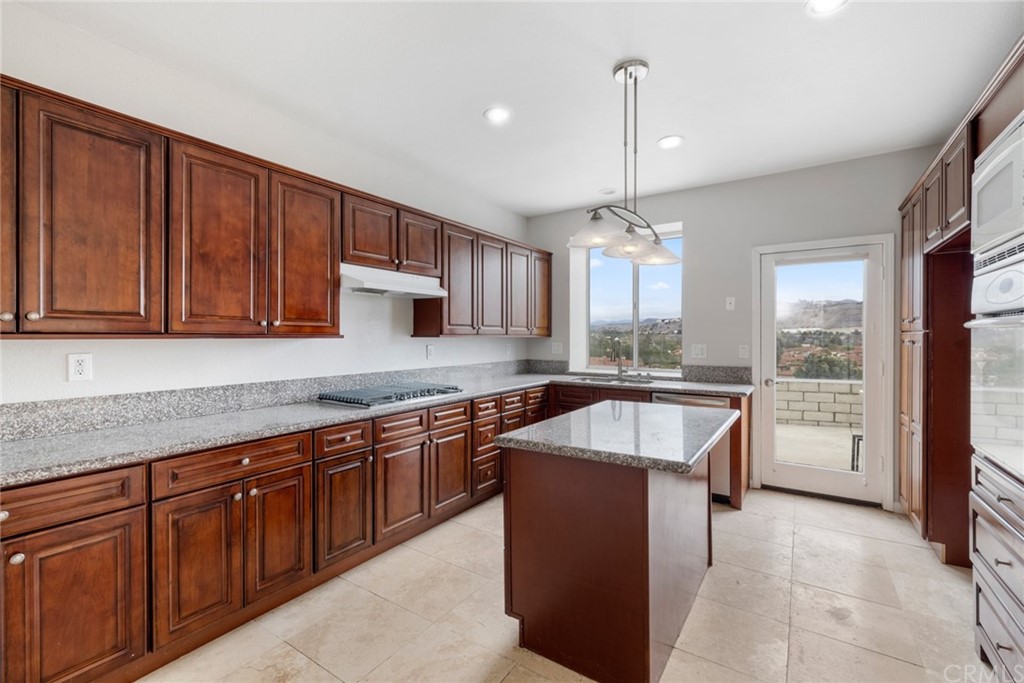 33696 Bridgehampton Drive Dana Point, CA 92629 - Photo 6 of 20 a kitchen with kitchen island granite countertop a sink stove and cabinets