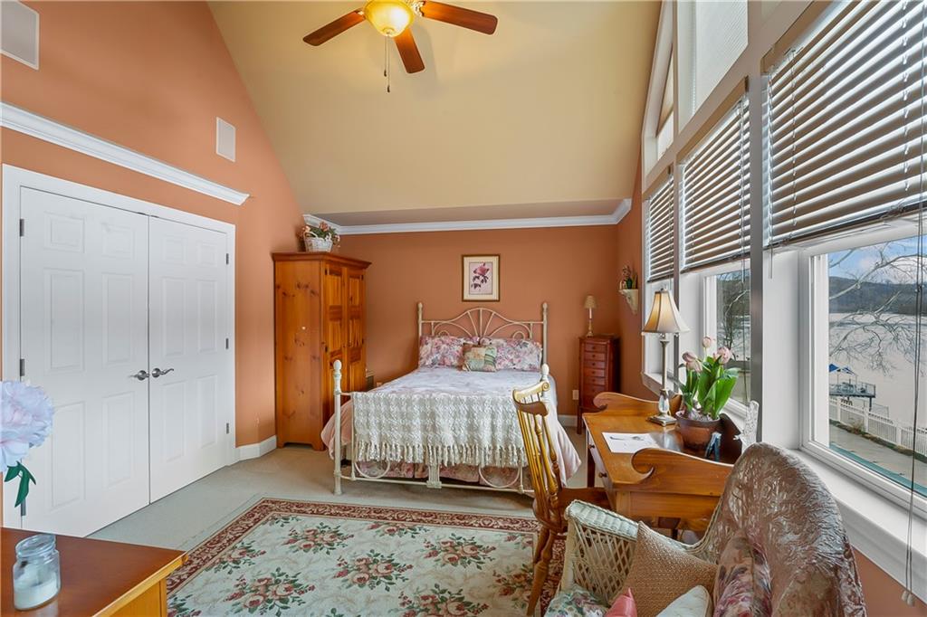 222 Arch Street, Unit E Verona, PA 15147 - Photo 11 of 24 a bedroom with a bed and a chandelier