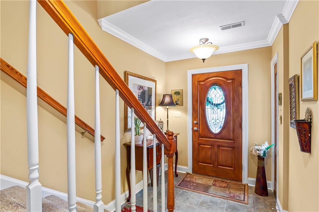 222 Arch Street, Unit E Verona, PA 15147 - Photo 2 of 24 a view of a hallway with painted walls and chandelier