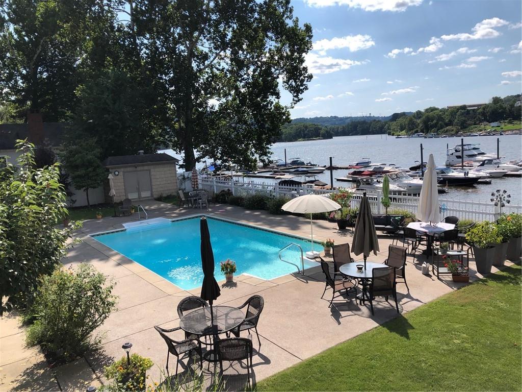 222 Arch Street, Unit E Verona, PA 15147 - Photo 22 of 24 a view of a chairs and table in patio with a lake view