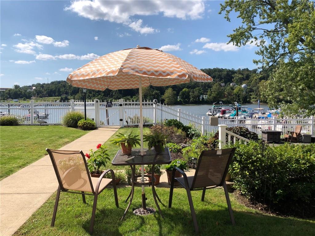 222 Arch Street, Unit E Verona, PA 15147 - Photo 23 of 24 a patio with a table and chairs under an umbrella