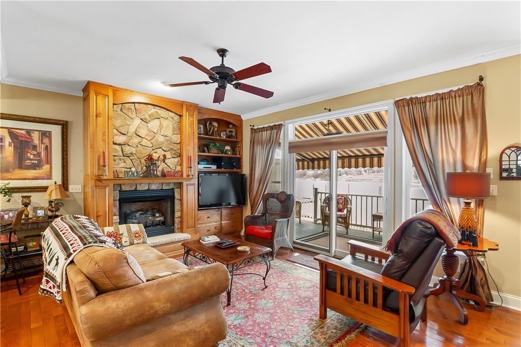 222 Arch Street, Unit E Verona, PA 15147 - Photo 4 of 24 a living room with furniture a fireplace and a flat screen tv