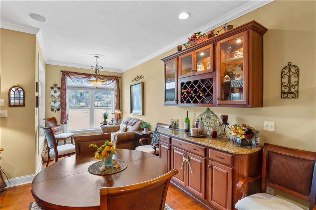 222 Arch Street, Unit E Verona, PA 15147 - Photo 5 of 24 a dining room with furniture a rug and wooden floor
