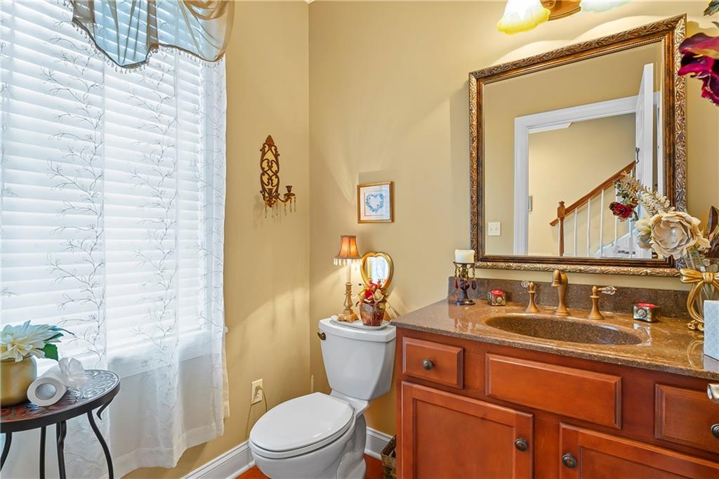 222 Arch Street, Unit E Verona, PA 15147 - Photo 8 of 24 a bathroom with a toilet a sink and mirror