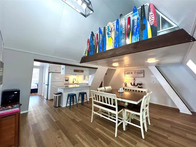 a room with lots of furniture and wooden floor