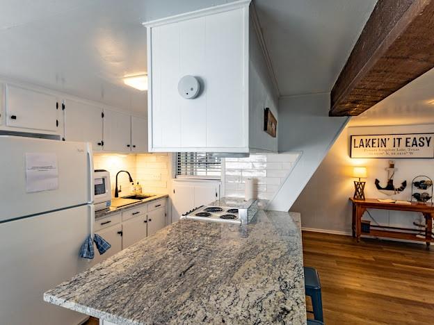 3817 Blue Fin Road Caddo, TX 76429 - Photo 16 of 40 a kitchen with granite countertop a sink stove and cabinets