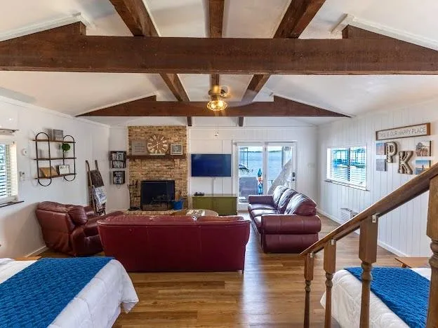 a living room with furniture a fireplace and wooden floor