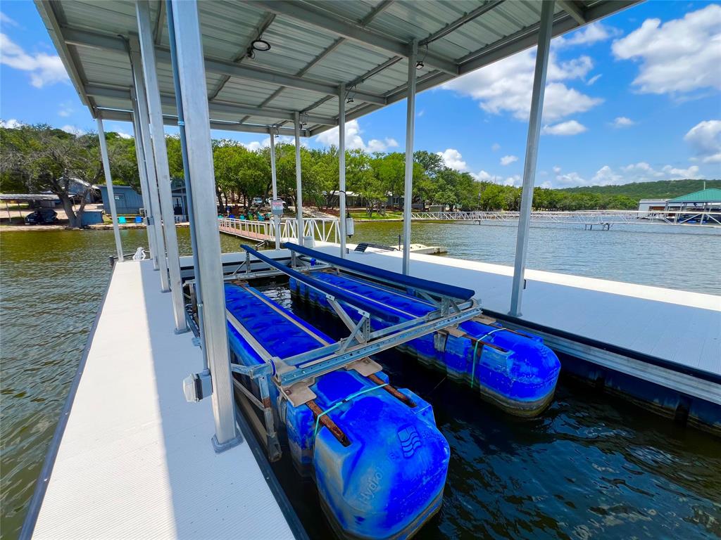 3817 Blue Fin Road Caddo, TX 76429 - Photo 10 of 40 a view of a swimming pool with red chairs in front of house