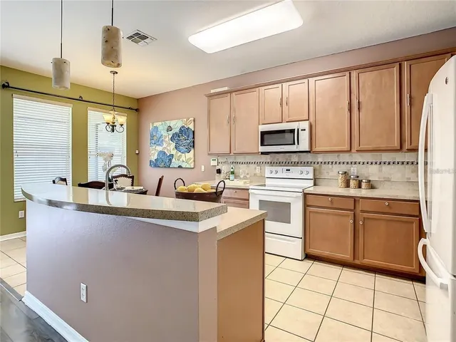 a kitchen with a sink stove and microwave