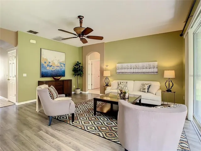 a living room with furniture and a wooden floor