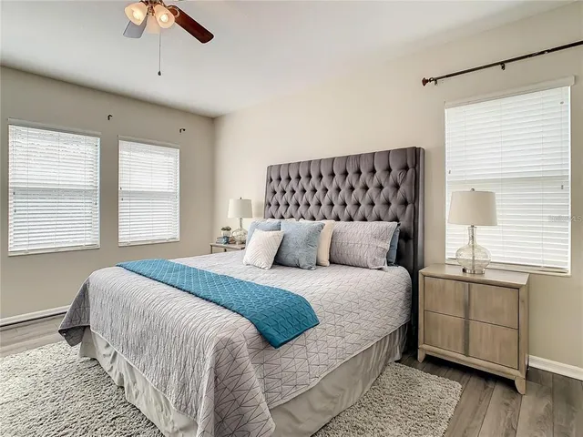 a bedroom with a large bed and a chandelier