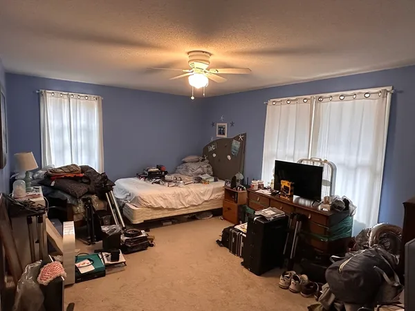 a bedroom with a bed and a chandelier