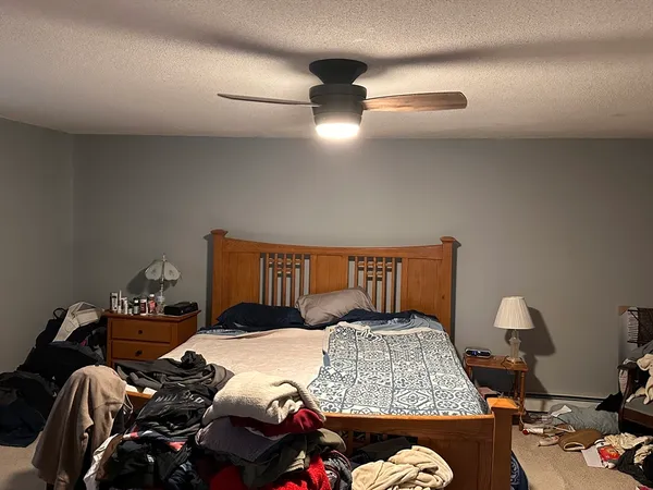 a bedroom with a bed and window