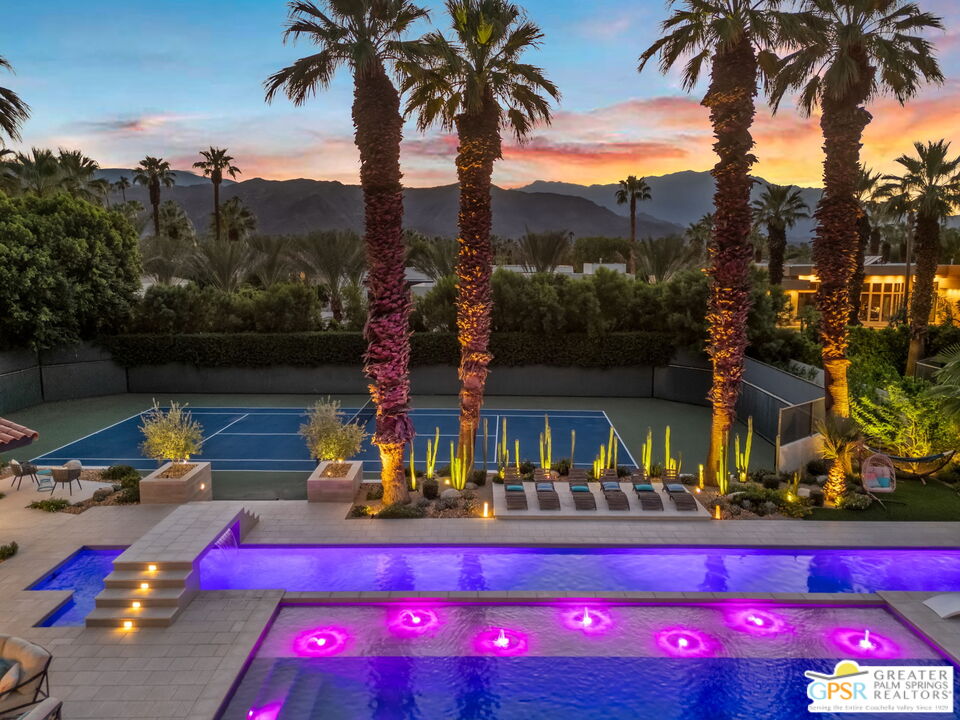 a view of swimming pool with a table and chairs
