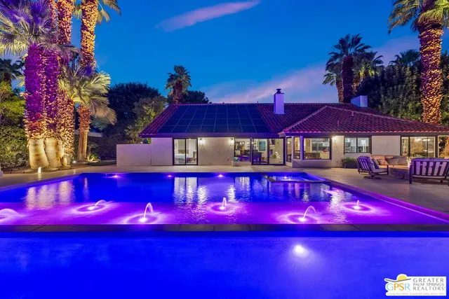 a view of a house with a sink and yard with swimming pool
