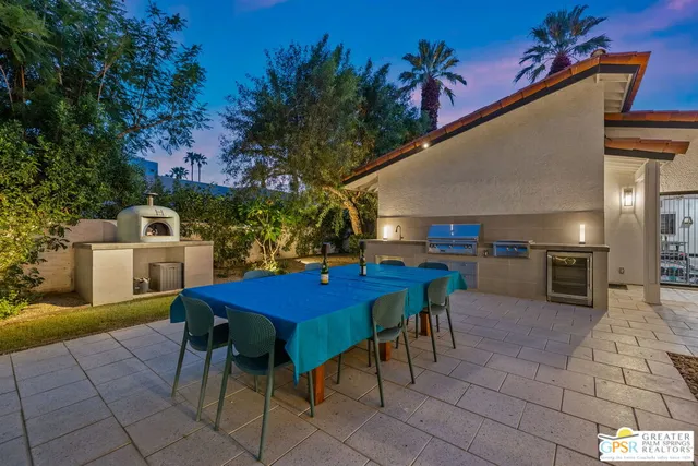 a living room with furniture a flat screen tv and a window