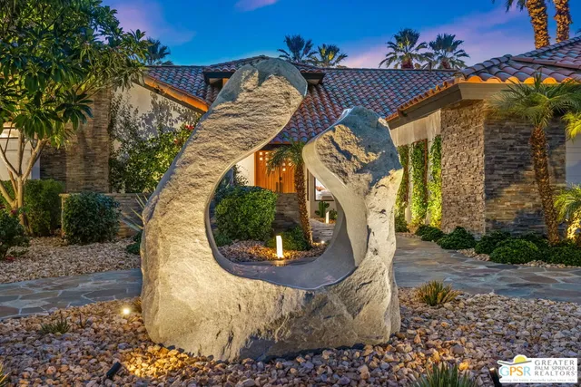 a bedroom with furniture and a large window