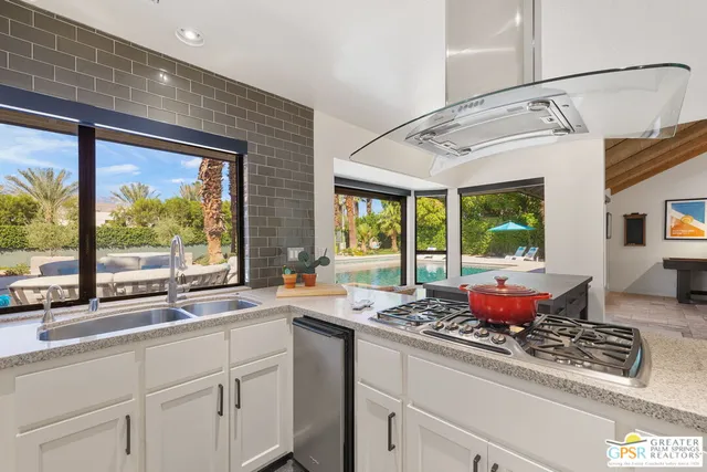 a bathroom with granite countertop a sink and a mirror