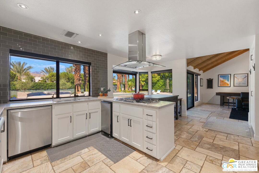 40563 Desert Creek Lane Rancho Mirage, CA 92270 - Photo 35 of 75 a kitchen with stainless steel appliances a sink and a large window