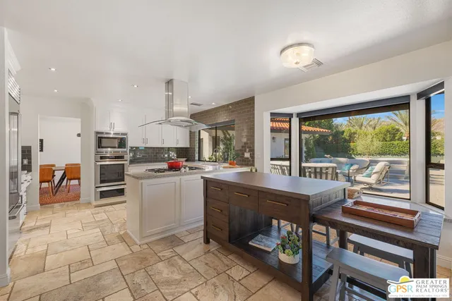 a spacious bedroom with a bed and a chandelier
