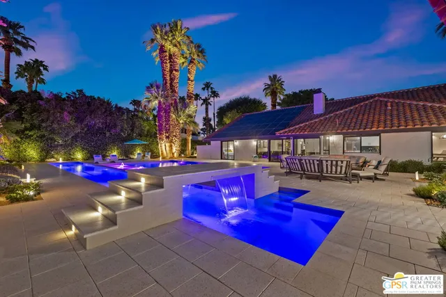 a view of swimming pool with sitting area and fire pit