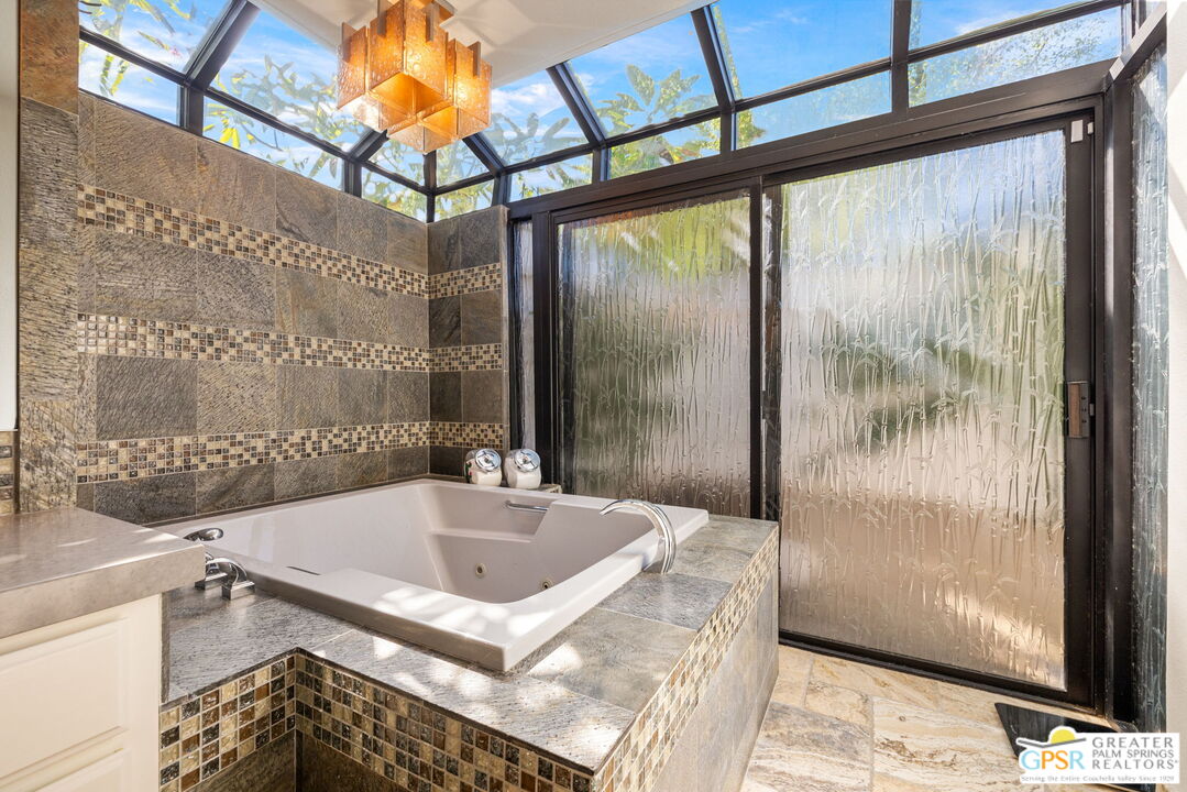 40563 Desert Creek Lane Rancho Mirage, CA 92270 - Photo 48 of 75 a bathroom with a tub and a shower