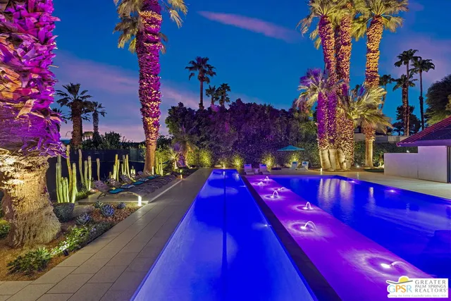 a view of swimming pool with a table and chairs and a fire pit