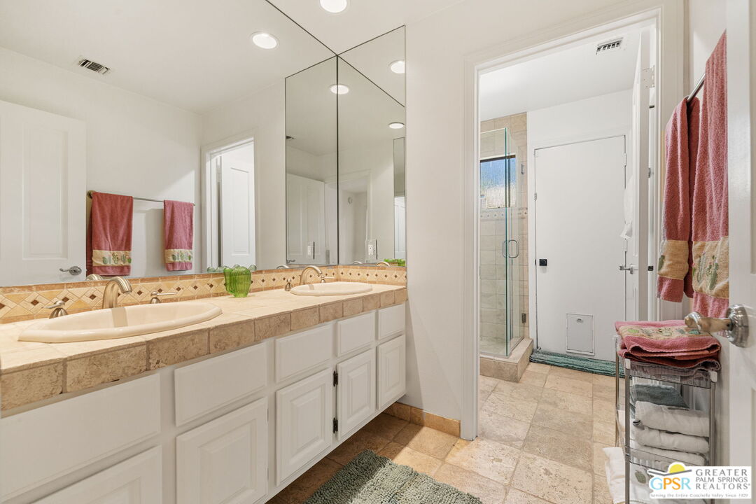 40563 Desert Creek Lane Rancho Mirage, CA 92270 - Photo 56 of 75 a bathroom with a double vanity sink and a mirror