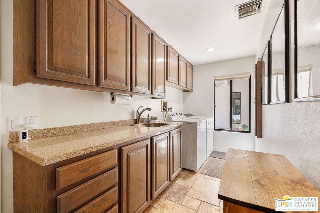 40563 Desert Creek Lane Rancho Mirage, CA 92270 - Photo 58 of 75 a kitchen with stainless steel appliances granite countertop a sink stove and cabinets