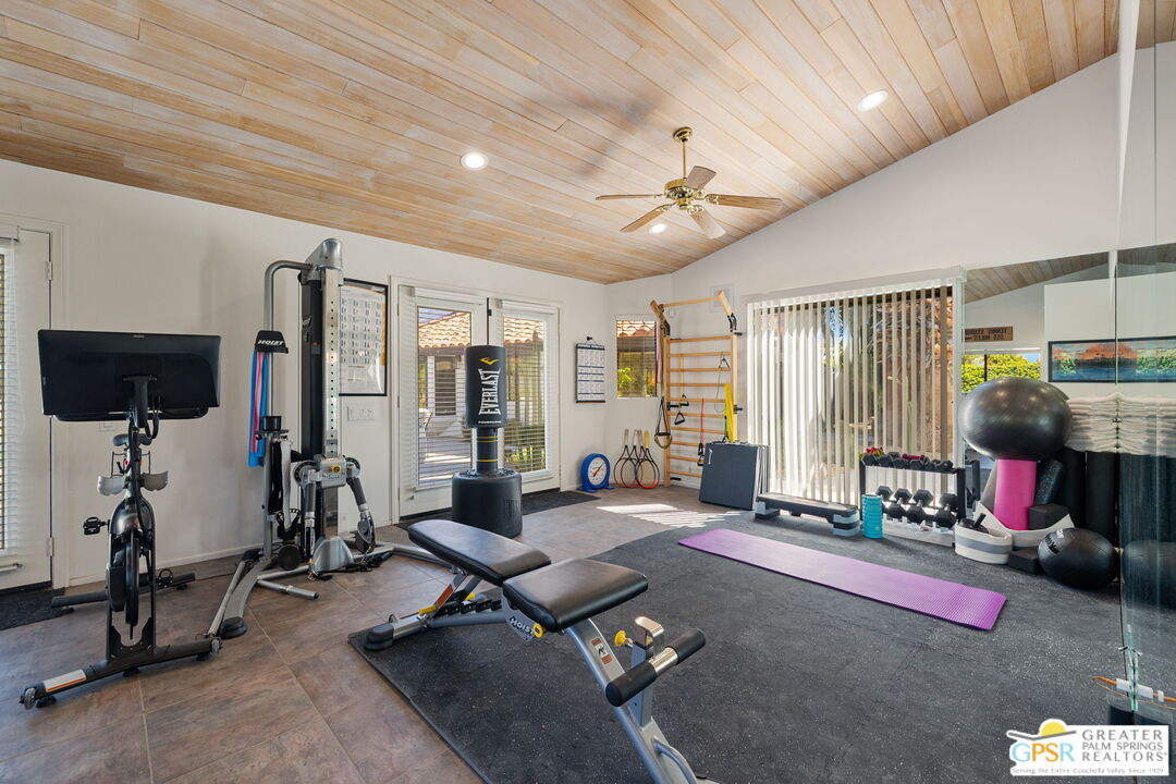 40563 Desert Creek Lane Rancho Mirage, CA 92270 - Photo 59 of 75 a living room with furniture gym equipment and a large window
