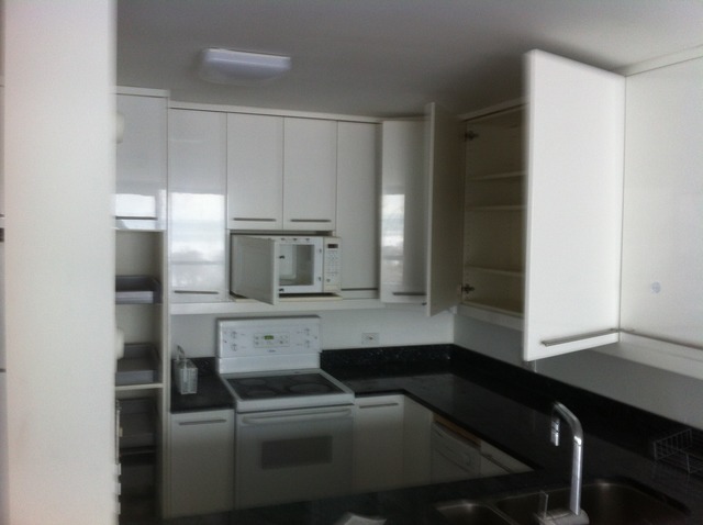 5415 North Sheridan Road, Unit 1002 Chicago, IL 60640 - Photo 6 of 11 a kitchen with a refrigerator and white cabinets