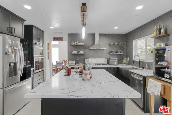 a large kitchen with stainless steel appliances lots of counter space and breakfast area