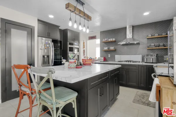 a kitchen with a table chairs sink and cabinets