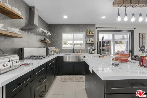 a kitchen with a sink stove and cabinets