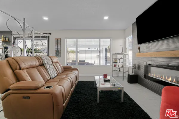 a living room with furniture fireplace and a flat screen tv