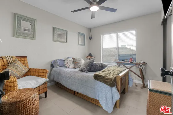 a bedroom with furniture and a large window